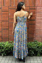 Back of Malini Agarwal wearing the Insia Spaghetti Dress, a women's cobalt blue viscose georgette maxi dress featuring a vibrant multicolour print, delicate spaghetti straps and a flowing 54-inch silhouette, styled for summer holidays, beach getaways, resort evenings and destination celebrations.