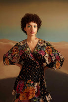 Marika Wrap Dress women's black Lurex viscose dress featuring sequenced embroidery, a shimmering printed georgette finish and a flattering wrap silhouette, styled for cocktail evenings, festive gatherings, dinner dates and special occasions.