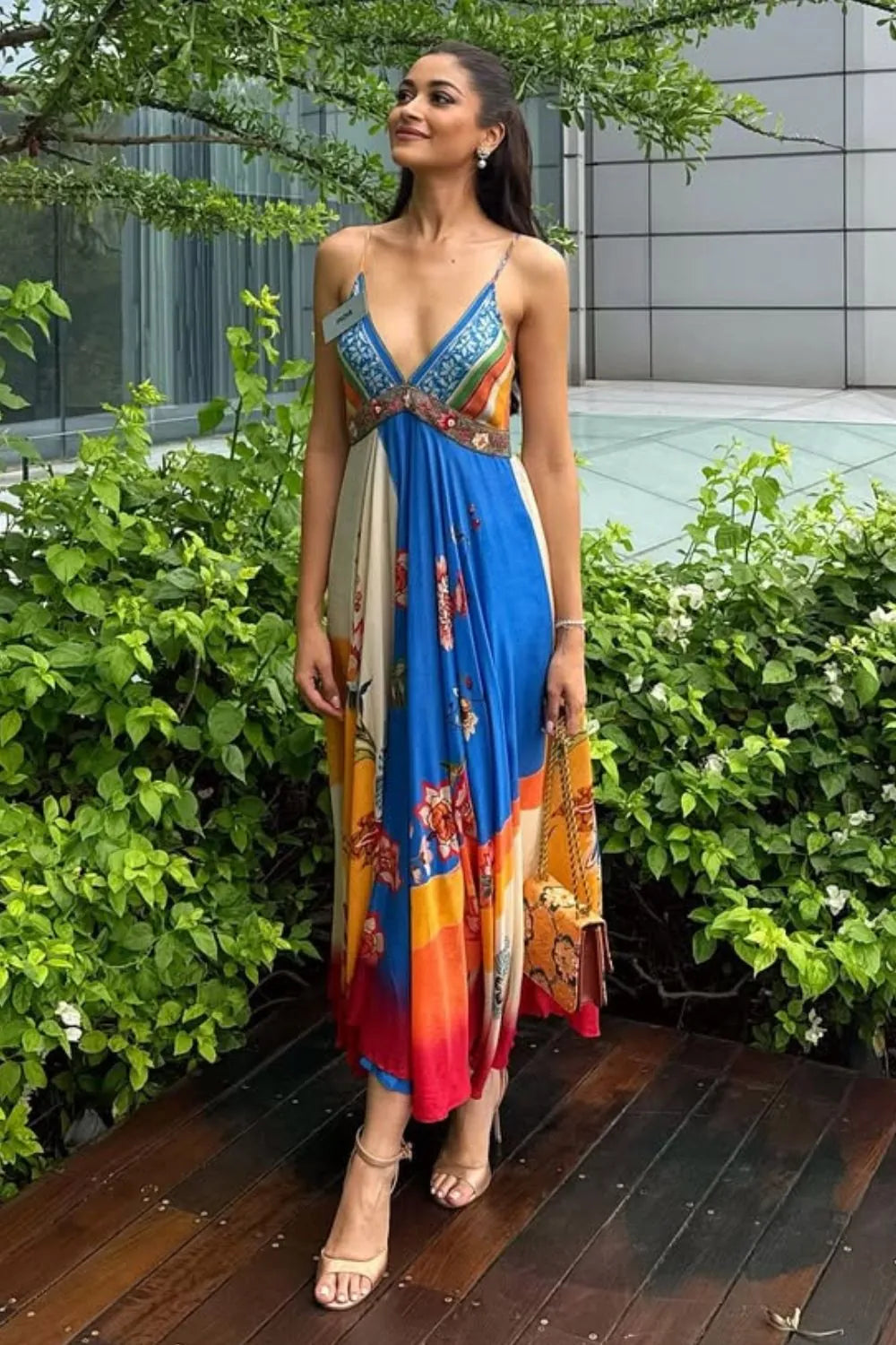 Nandini Gupta wearing the Ayla Dress, a women's multicolour satin maxi dress featuring an engineered floral print, plunging neckline, embroidered beaded neckline and adjustable smocked back, styled for resort vacations, summer holidays and casual day outings.