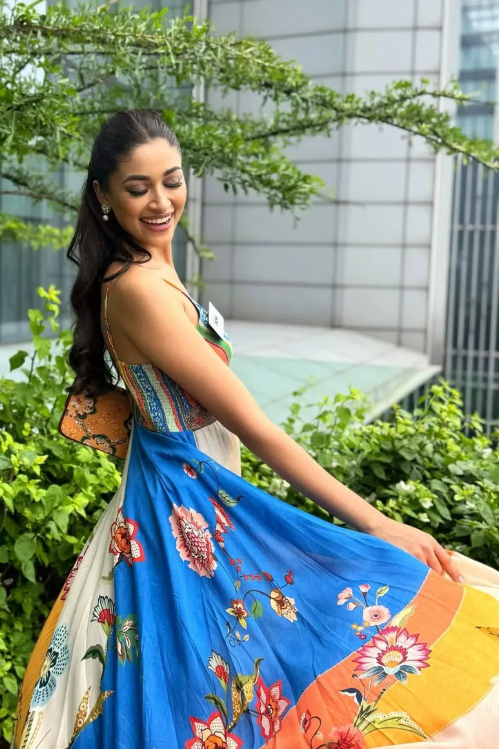 Nandini Gupta wearing the Ayla Dress, a women's multicolour satin maxi dress featuring an engineered floral print, plunging neckline, embroidered beaded neckline and adjustable smocked back, styled for resort vacations, summer holidays and casual day outings.