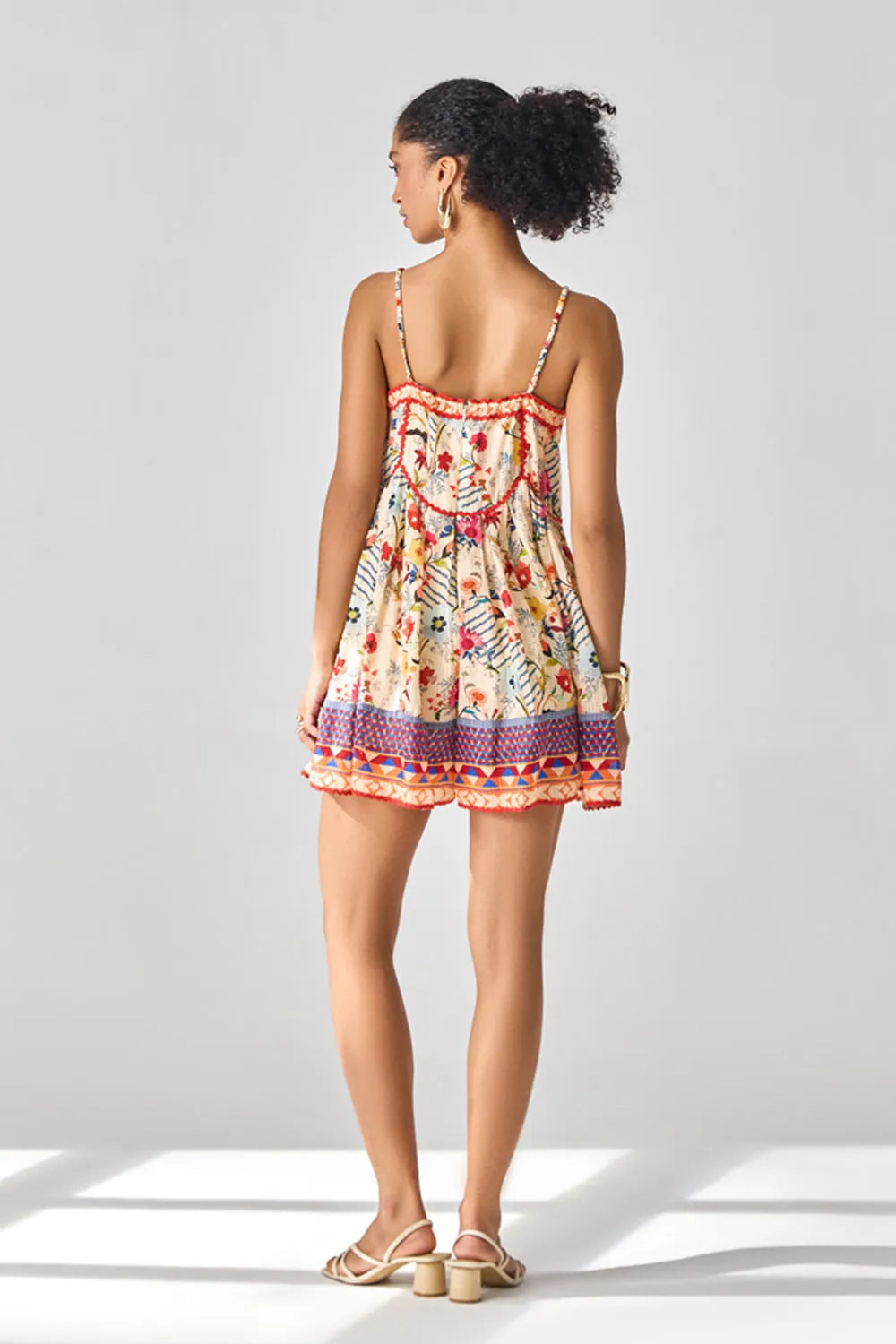 Back view of Nora Playsuit women's playsuit featuring a vibrant multicolour printed design, delicate spaghetti straps and a relaxed, flattering silhouette, styled for summer holidays, beach vacations, resort outings and casual daytime gatherings.