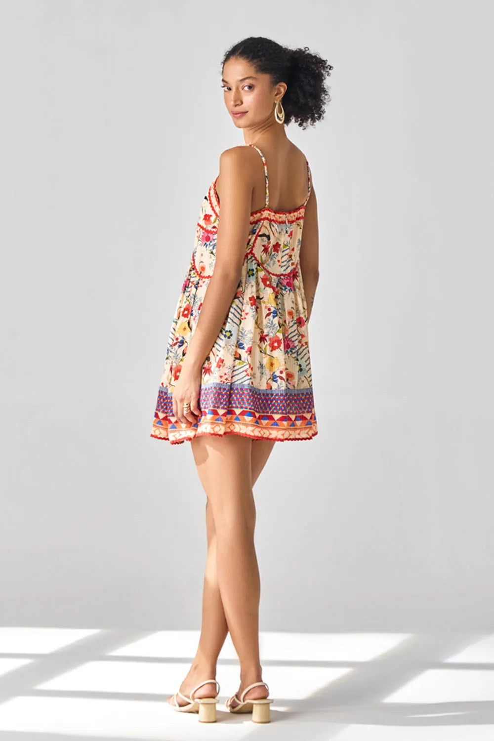 Side view of Nora Playsuit women's playsuit featuring a vibrant multicolour printed design, delicate spaghetti straps and a relaxed, flattering silhouette, styled for summer holidays, beach vacations, resort outings and casual daytime gatherings.