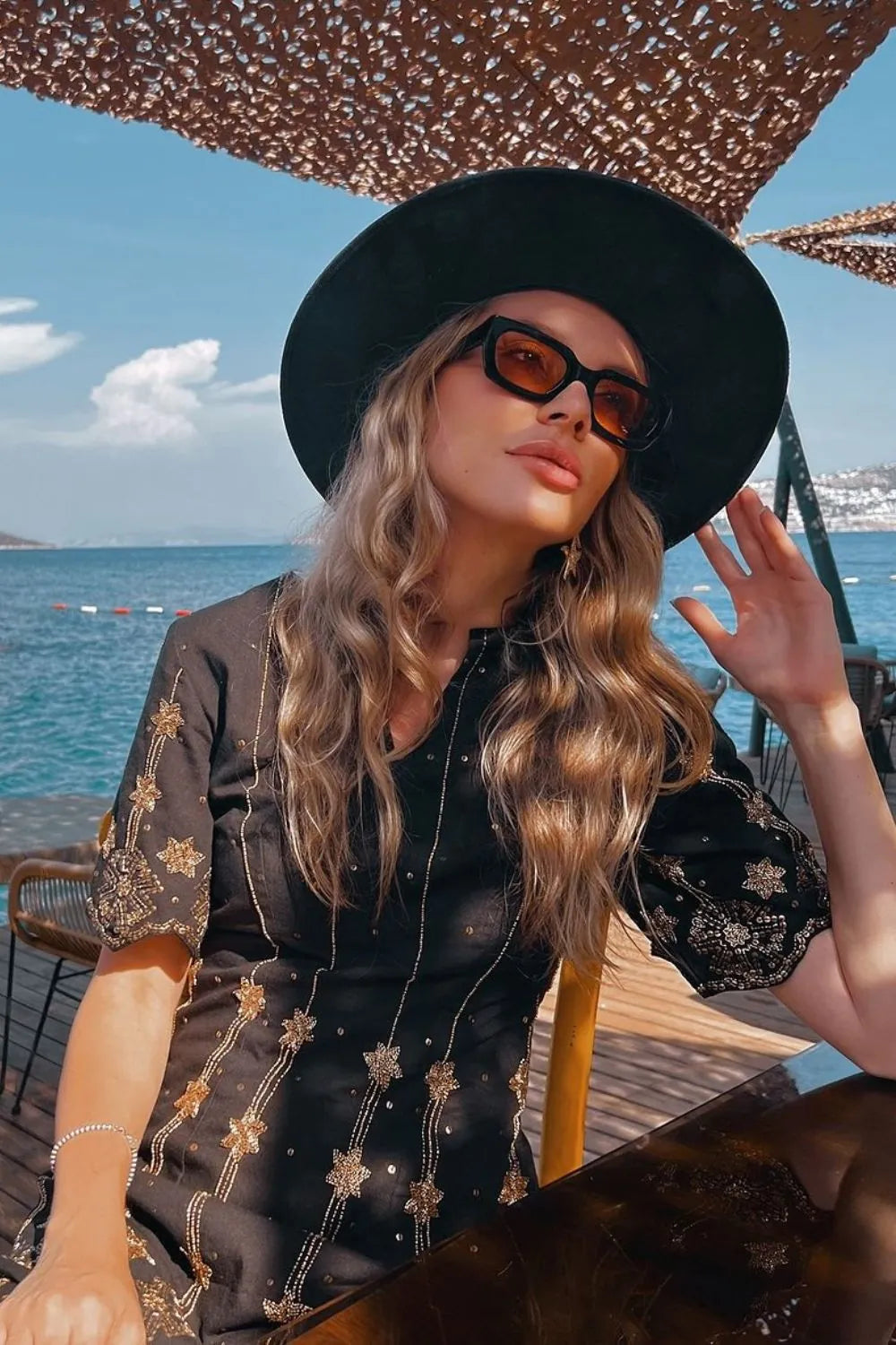 Olga O wearing the Aira Mini Dress, a women's printed mini dress featuring a vibrant multicolour design, a flattering silhouette and contemporary detailing, styled for summer brunches, resort vacations, holiday outings and daytime celebrations.