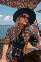 Olga O wearing the Aira Mini Dress, a women's printed mini dress featuring a vibrant multicolour design, a flattering silhouette and contemporary detailing, styled for summer brunches, resort vacations, holiday outings and daytime celebrations.