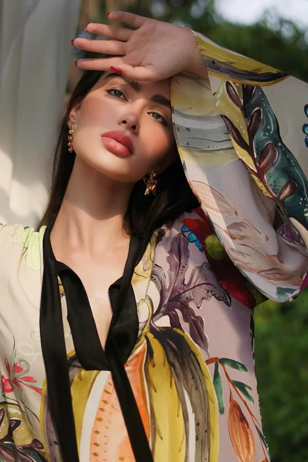 Rawan Bin Hussain wearing the Jianna Dress, a women's multicolour double georgette maxi dress featuring a vibrant mixed print, dramatic flared sleeves and a flowing floor-length silhouette, styled for resort vacations, summer celebrations, destination dinners and elegant daytime occasions.