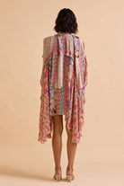 back view of Rilla Dress women's multicolour viscose Lurex Georgette swing dress featuring a jacquard colour-blocked print, chic scarf neckline and asymmetric high-low hem, designed with a relaxed non-waisted silhouette for resort vacations, summer brunches, holiday outings and statement daytime occasions.