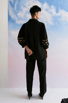 Back view of Rimi Shirt women's black cotton shirt featuring a relaxed silhouette, classic collared neckline, button-down front and clean contemporary styling, designed for comfortable everyday wear, styled for casual outings, travel days, brunches and smart-casual occasions.