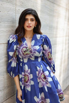 Sanjana Sanghi wearing the Amara Mini Dress, a women's cobalt blue cotton satin mini dress featuring a vibrant printed design and a relaxed swing silhouette, styled for summer outings, brunches, resort vacations and casual celebrations.