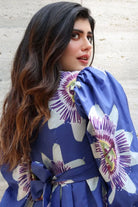 Back Closeup look of Sanjana Sanghi wearing the Amara Mini Dress, a women's cobalt blue cotton satin mini dress featuring a vibrant printed design and a relaxed swing silhouette, styled for summer outings, brunches, resort vacations and casual celebrations.