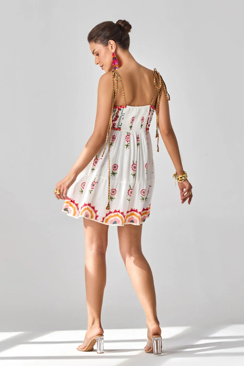 Back view of Tashi Embroidered Mini Dress women's mini dress featuring intricate embroidery, decorative embellishments and a flattering contemporary silhouette, styled for summer brunches, resort vacations, festive gatherings and special occasions.