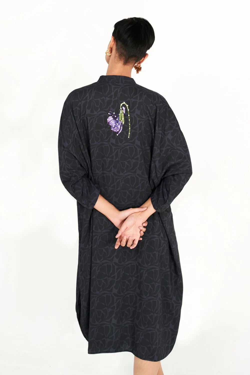 Back view of Tushita Dress women's statement dress featuring a feminine silhouette and distinctive contemporary detailing, styled for summer celebrations, resort vacations, brunches and special occasions.