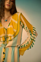 Closeup view of Vida Blouse women's statement blouse featuring a feminine silhouette and contemporary styling, designed for versatile pairing with tailored trousers, skirts or denim, styled for summer outings, resort vacations, brunches and casual celebrations.