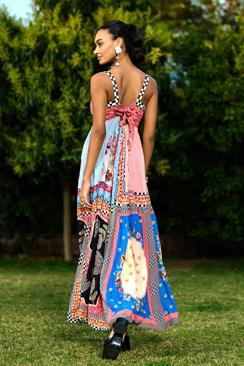 Back view of Aarna Beaded Spaghetti Women's pink printed sleeveless maxi dress with checkerboard trim and vibrant bohemian pattern, styled for resort vacations, summer holidays and brunch outings.