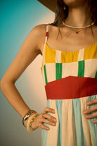 Closeup of aida spaghetti straps dress with bold yellow and cyan with red band cotton-linen perfect for brunch or holidays.