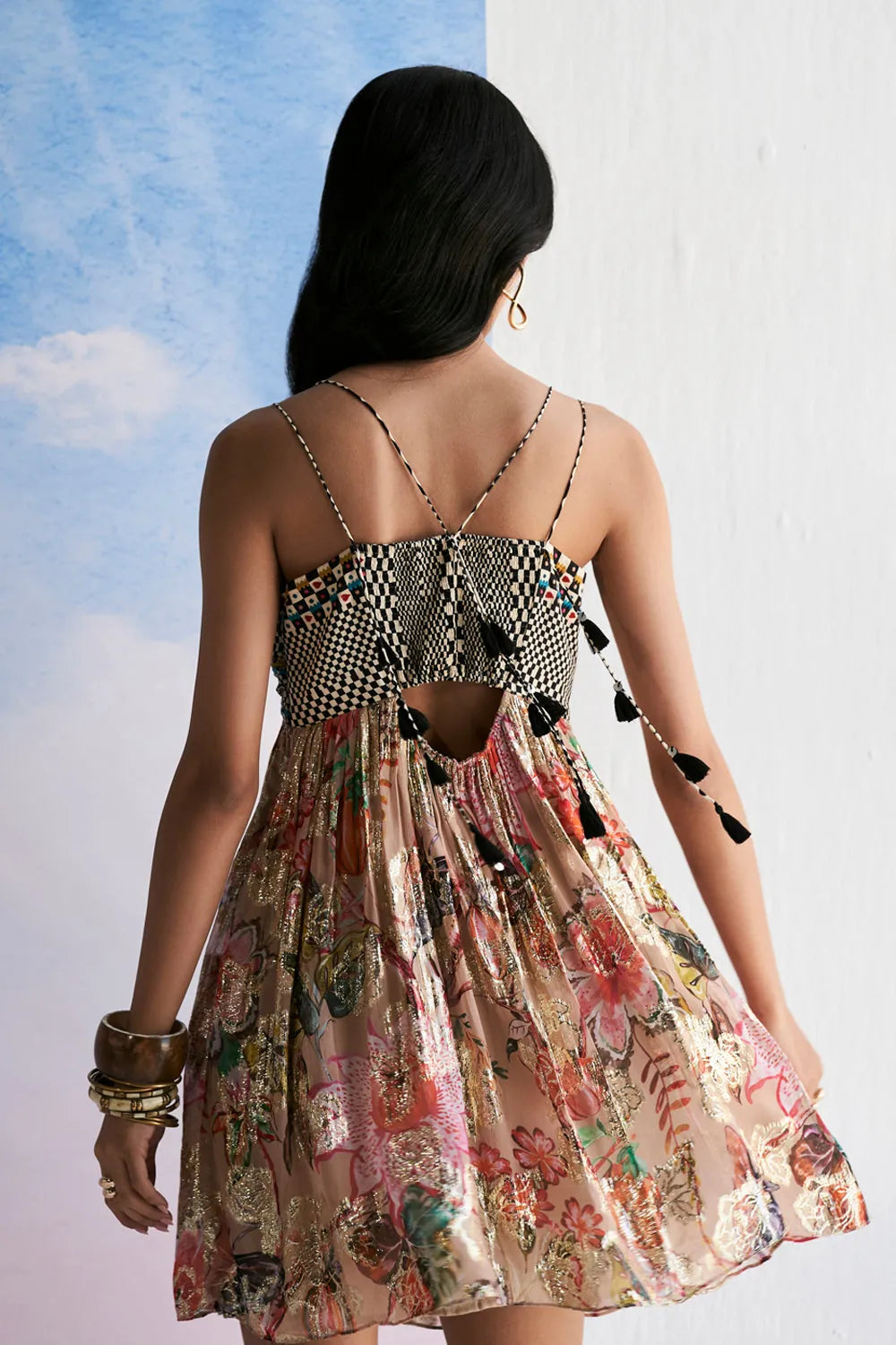 Back view of Anvena Lily dress showing the detailed embellished bodice, thin shoulder straps and flowing floral printed skirt