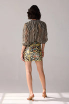 Back view of Aria multicolour floral mini skirt featuring a fitted silhouette and intricate botanical print