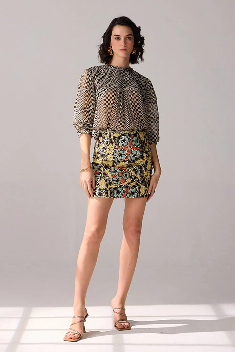 Side view of Aria floral mini skirt showing its fitted mini silhouette and detailed multicolour botanical print