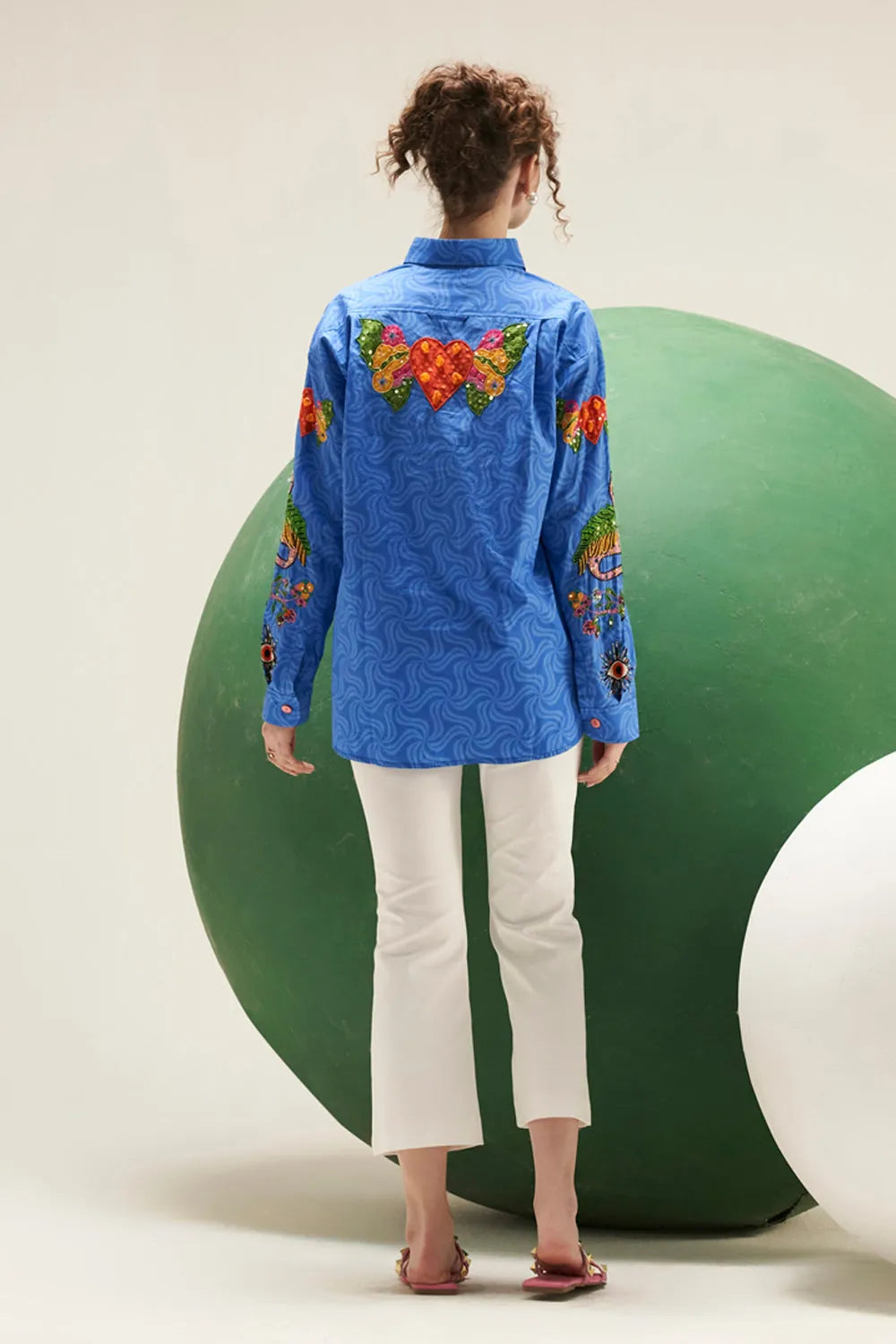 Back view of Arin cobalt blue cotton shirt showing its relaxed silhouette, long sleeves and colourful embroidered detailing