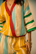 Colorful striped outfit with a focus on a sleeveless top and pants.