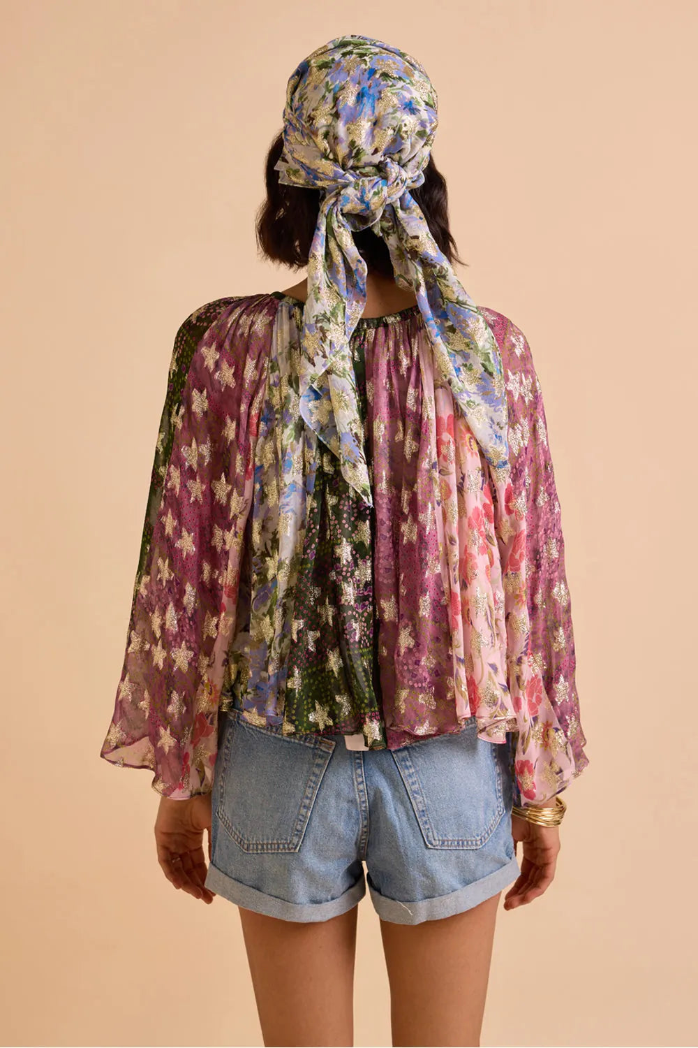 Detailed back view of Avita printed blouse showing colourful floral pattern, flowing sleeves and relaxed draped fit