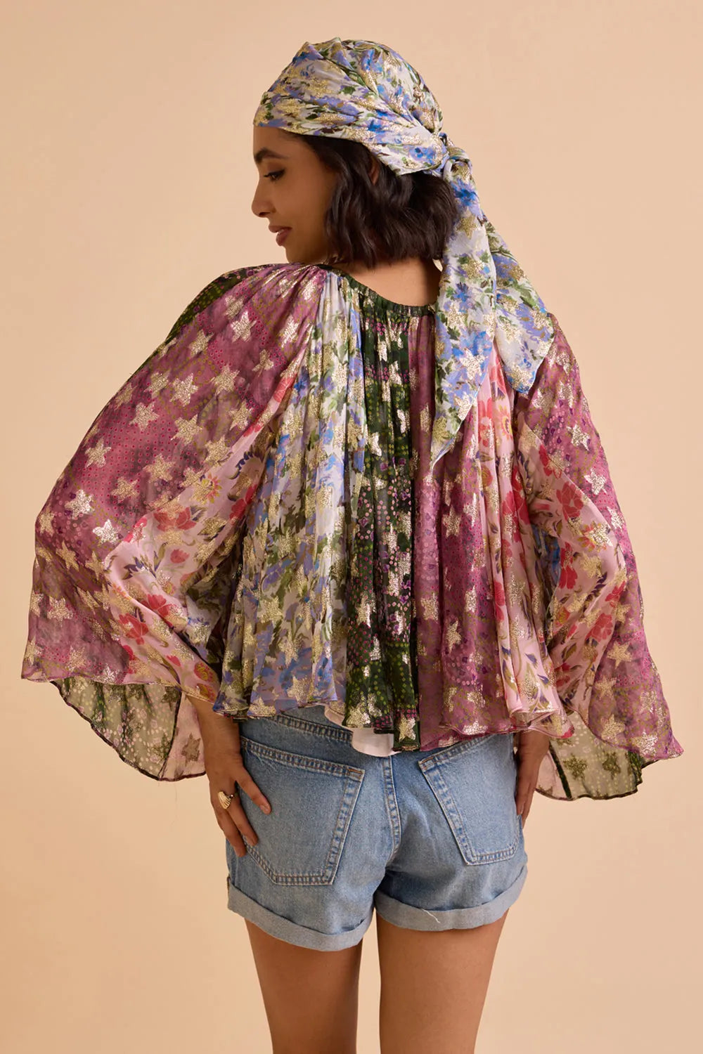 Back view of Avita multicolour printed blouse featuring a relaxed silhouette, wide sleeves and vibrant floral pattern