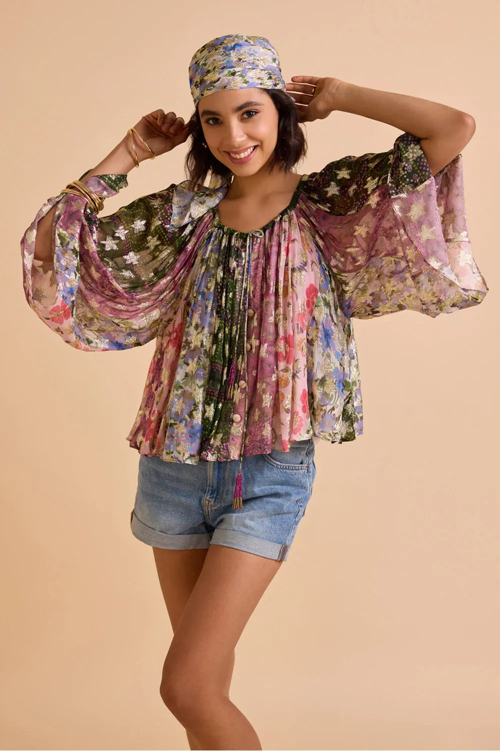 Avita printed blouse featuring a vibrant multicolour floral pattern, relaxed silhouette, wide flowing sleeves, round neckline and gathered detailing