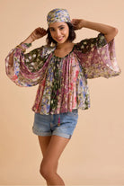 Avita printed blouse featuring a vibrant multicolour floral pattern, relaxed silhouette, wide flowing sleeves, round neckline and gathered detailing
