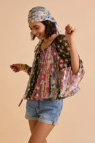 Side view of Avita multicolour printed blouse showing its relaxed fit, wide flowing sleeves and lightweight draped silhouette
