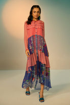 Woman wearing a red and blue striped dress with a clean background