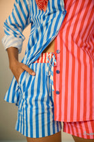 Close-up look of colorful co-ord set with a blue and pink striped shirt and shorts.