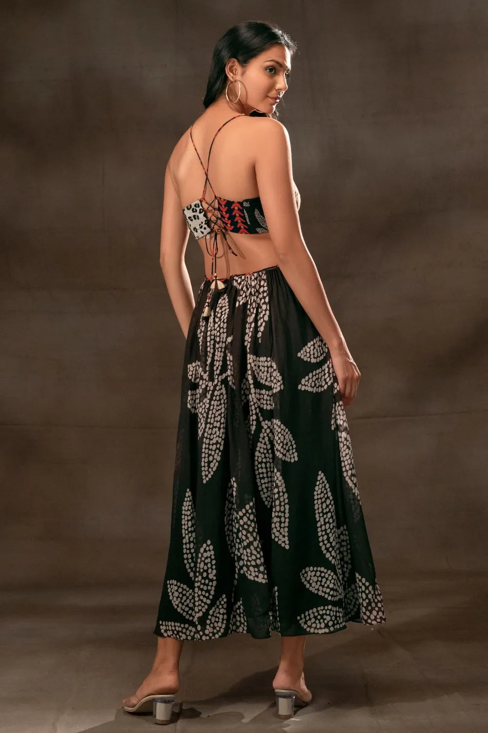 Back view of Woman in Martha Multipatch/Stippling Printed Cutout Dress in classic black viscose georgette fabric, perfect for your holiday adventures for women